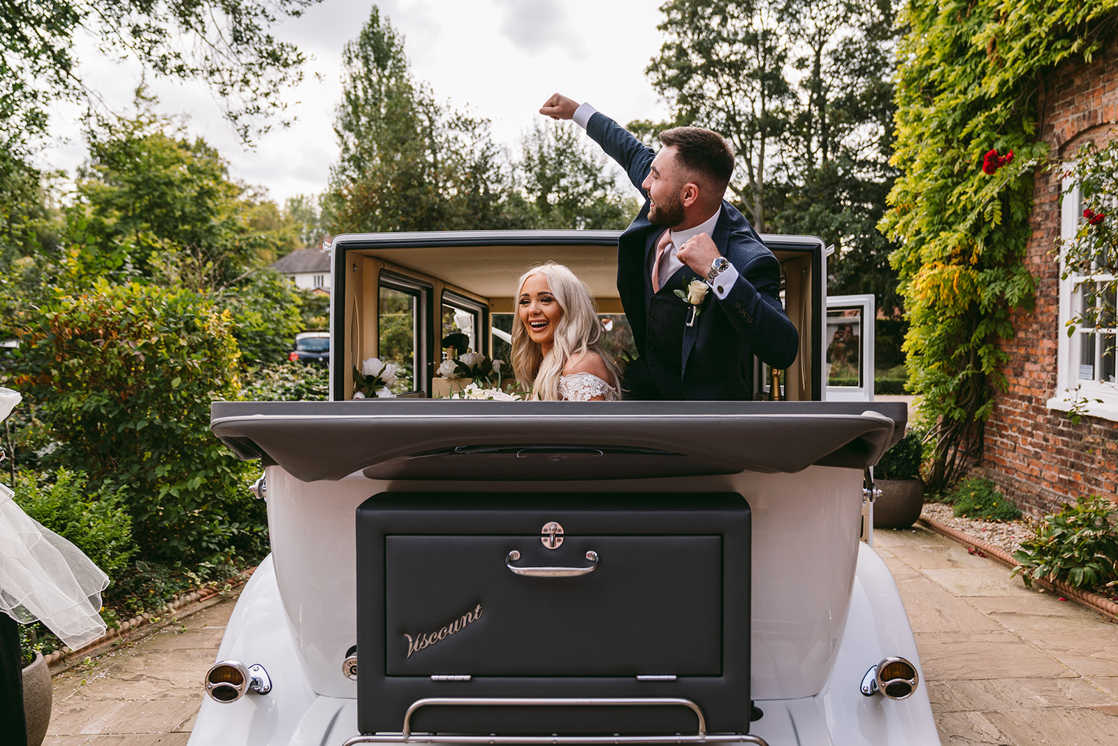 Happy couple in wedding vehicle