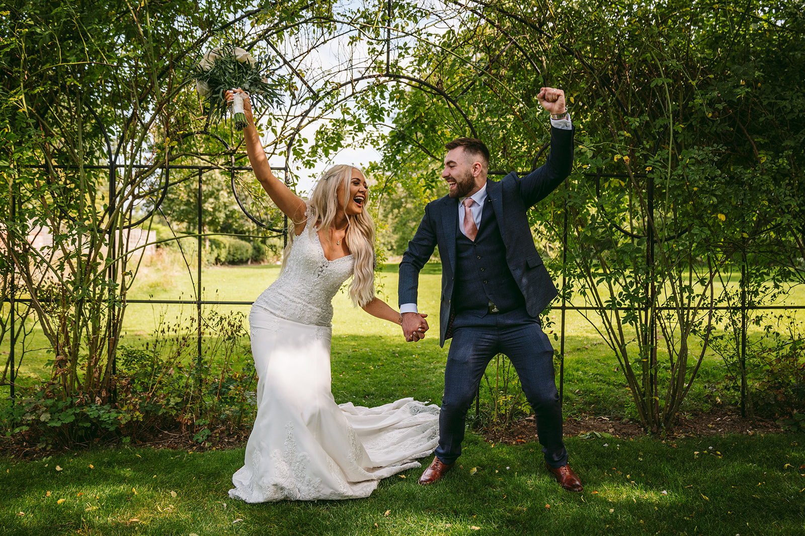 happy couple posing in outdoor wedding event