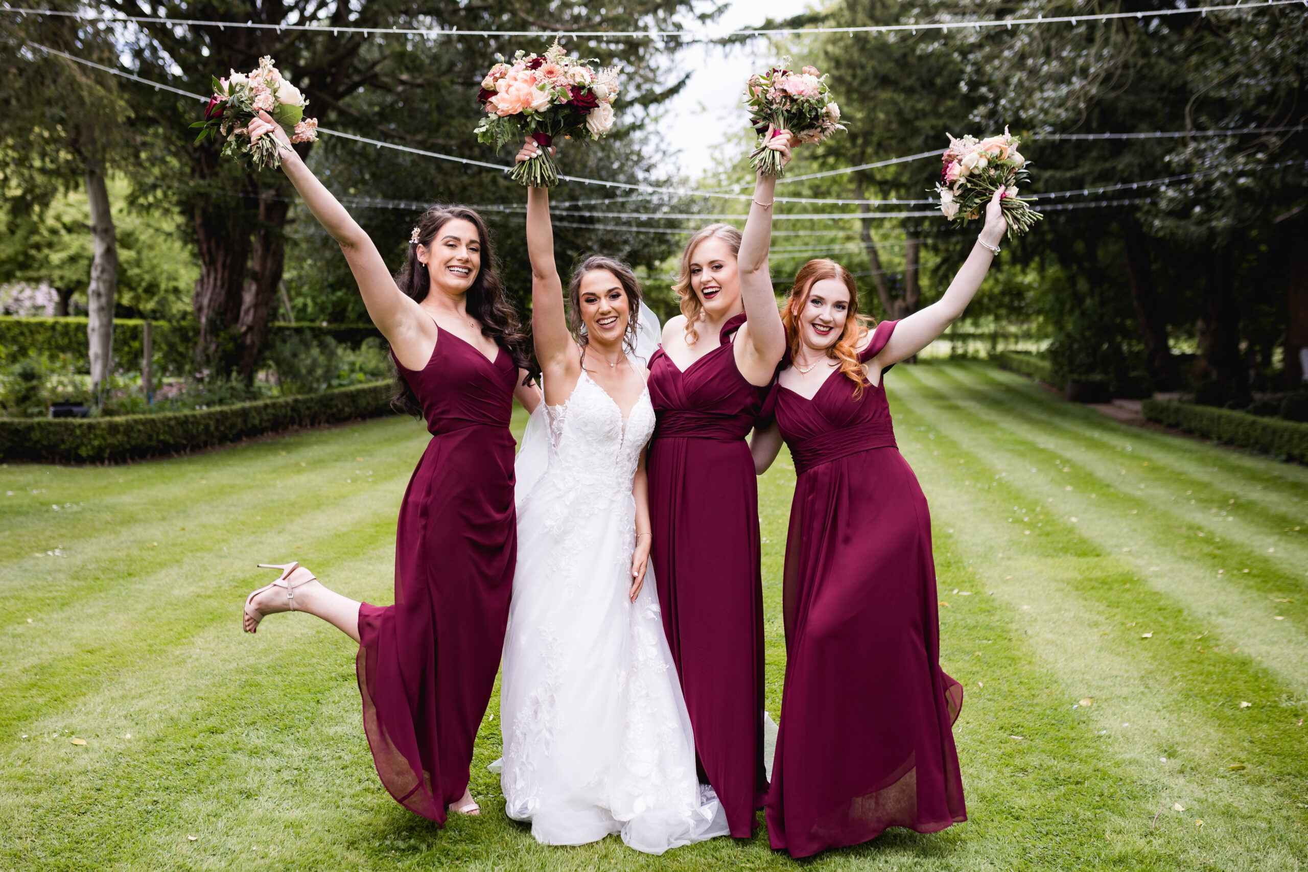 bridal party holding bouquets of flowers